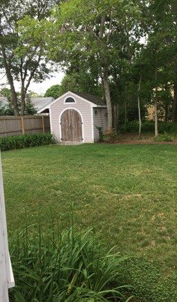 Falmouth Cape Cod vacation rental - Back yard with shed storage for beach chairs, umbrella & buggy