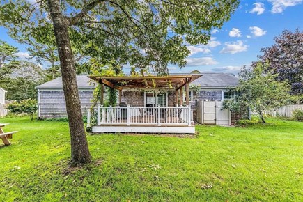 West Yarmouth Cape Cod vacation rental - Back Yard.  Pergola over top of porch has removed.