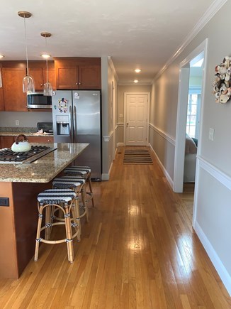 Harwich Cape Cod vacation rental - Kitchen hall. Pantry and laundry on the left. Doorway to mudroom