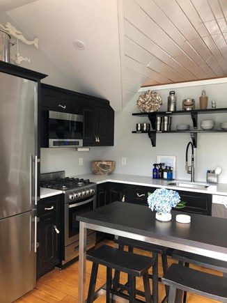 Mashpee Cape Cod vacation rental - Kitchen boasts stainless steel appliances and marble countertops.