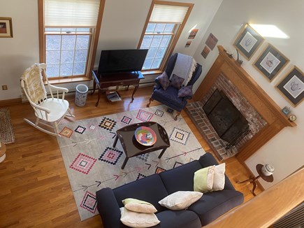 North Eastham Cape Cod vacation rental - Living room with fireplace, and big windows to the front.