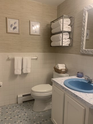 Dennis Cape Cod vacation rental - Main bathroom with bathtub/shower cabinet storage