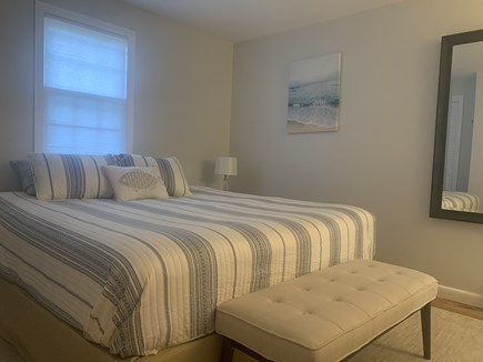 Dennis Cape Cod vacation rental - King bed, nightstands, tv, desk, closet, and 1/2 bath.