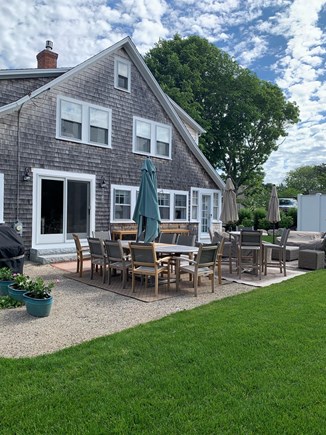 Harwich Port Cape Cod vacation rental - Side yard offers plenty of seating for outdoor gathering