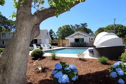 Dennis Cape Cod vacation rental - Backyard views of pool & lounge chairs
