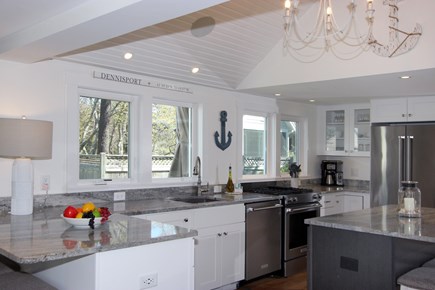 Dennis Cape Cod vacation rental - Bright kitchen with stainless appliances & counter seating.