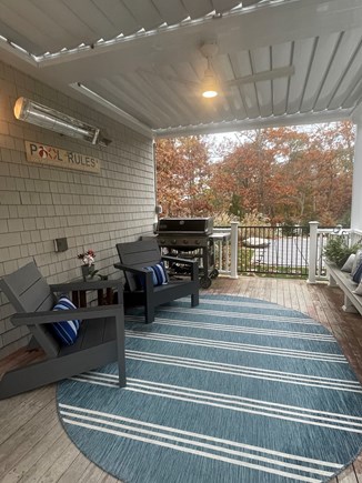 Sandwich Cape Cod vacation rental - Covered back porch with remote pergola to let the sunshine in.