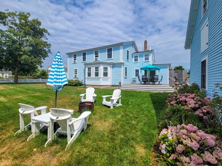 Harwich Cape Cod vacation rental - Fenced in yard with seating area and firepit