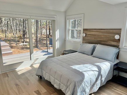 Wellfleet, Indian Neck Cape Cod vacation rental - Primary bedroom with queen bed, ensuite bath and slider onto deck