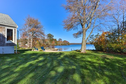 Centerville, Wequaquet Lake Waterfront Cape Cod vacation rental - Expansive private grassy tree-lined yard.