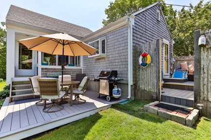 Centerville, Wequaquet Lake Waterfront Cape Cod vacation rental - Patio, weber grill, outdoor shower, and additional lounge set.