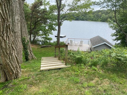 Orleans Cape Cod vacation rental - Deck, boathouse, and swim dock viewed from end of large lawn