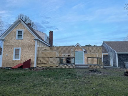 South Yarmouth Cape Cod vacation rental - Back yard with large deck, fire pit, fenced yard