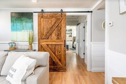 West Dennis Cape Cod vacation rental - Barn door and hallway to bedrooms.