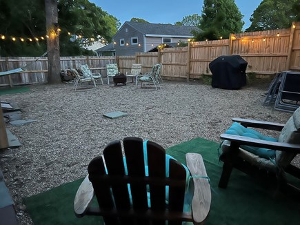 Yarmouth Cape Cod vacation rental - Fenced-in backyard with a fire pit, a grill and lounge chairs