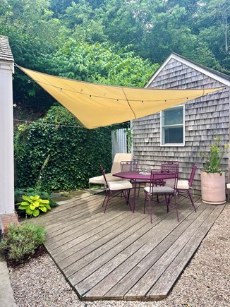 Provincetown West End Cape Cod vacation rental - Private covered patio with vintage dining and chaise set.