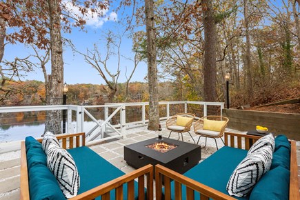 East Falmouth Cape Cod vacation rental - Water facing Patio area with fire pit and seating for 8 people.