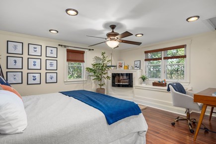 Harwich Cape Cod vacation rental - Primary bedroom with King sized bed, remote workspace and small electric fireplace