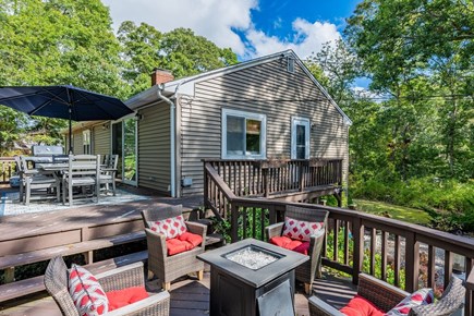 Harwich Cape Cod vacation rental - Multi-level deck offers a dining area as well as a lounge space with gas fire feature