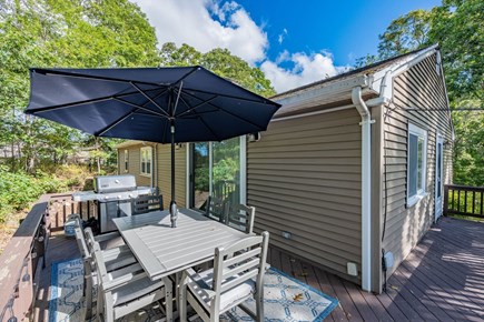 Harwich Cape Cod vacation rental - Access the deck through the door from the kitchen (right) or through the sliding doors of the living room (center)