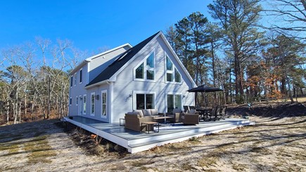 Wellfleet Cape Cod vacation rental - Home has a large deck with table and chairs and lounge seating