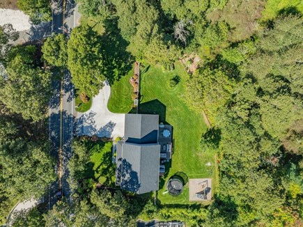 Harwichport Cape Cod vacation rental - Aerial view of outdoor living space, plaground and trampoline