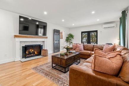 Chatham Cape Cod vacation rental - Leather sectional overlooking a large gas fire place.   75 in TV