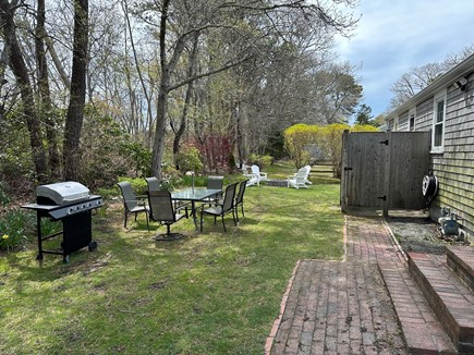 Dennis Cape Cod vacation rental - Private backyard with grill, table, fire pit and outdoor shower