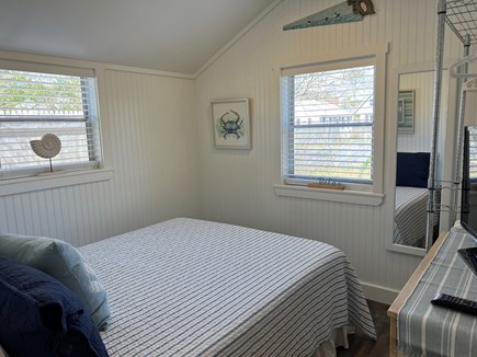 Dennis Cape Cod vacation rental - Queen bedroom has small dresser, smart TV, and clothes rack