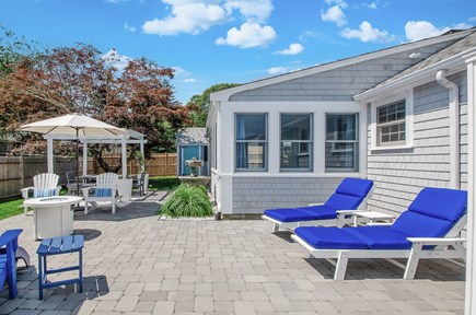 West Dennis Cape Cod vacation rental - Backyard Patio with pergola and recliners.