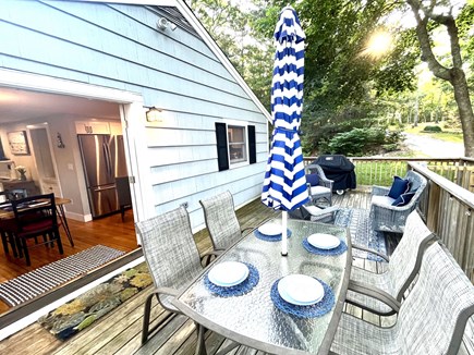 East Falmouth Cape Cod vacation rental - Deck dining area, lounge, and opens to the kitchen