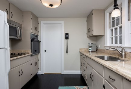 Centerville Cape Cod vacation rental - Spacious galley kitchen with a bathroom on the far side that is also connected to the hallway