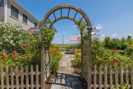 Sandwich Cape Cod vacation rental - Garden trellis entrance to patio  and facing the dock and creek