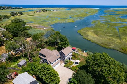 Sandwich Cape Cod vacation rental - Aerial view of home overlooking tidal creek, dunes and ocean.
