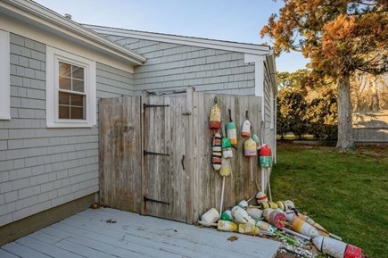 West Harwich Cape Cod vacation rental - A classic outdoor shower with brightly colored Cape buoys