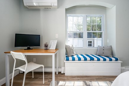 Sandwich Cape Cod vacation rental - Primary bedroom w/ King, en suite, desk, and walk-out to patio.