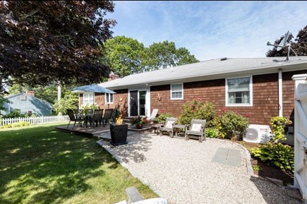 Yarmouth, Halfway Pond Cape Cod vacation rental - Mature fenced yard with deck and seating area with firepit.