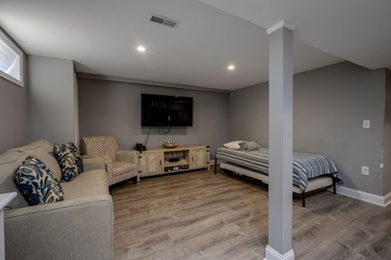 Hyannis Cape Cod vacation rental - Lower Level - Seating area with a Twin Trundle, Bathroom and Bar.