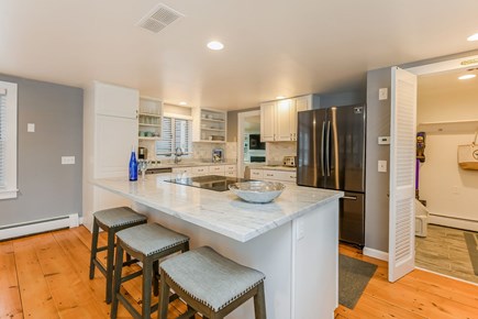Hyannis Cape Cod vacation rental - Kitchen with island and seating.