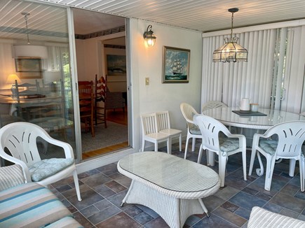 Harwich Cape Cod vacation rental - Sunroom with dining area and seating.