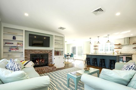Chatham Cape Cod vacation rental - Living room with fireplace and TV. Open concept.