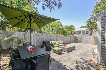 Harwich Port Cape Cod vacation rental - Backyard patio area with dining and seating.