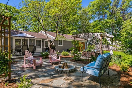 West Hyannisport Cape Cod vacation rental - Outdoor living with pergola, lights, fire pit and outdoor shower