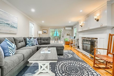 East Sandwich Cape Cod vacation rental - Living room with fireplace and access to back deck.