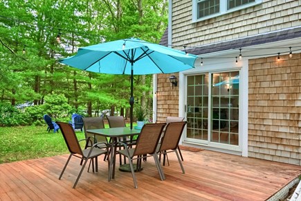 East Sandwich Cape Cod vacation rental - Backyard with a deck and dining area.