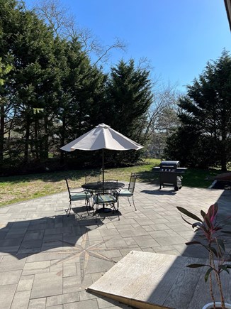 Harwich Cape Cod vacation rental - Large patio with seating and gas grill.