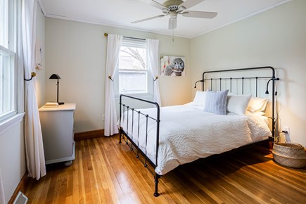Cotuit Cape Cod vacation rental - First level bedroom with a cozy queen bed and garden views.
