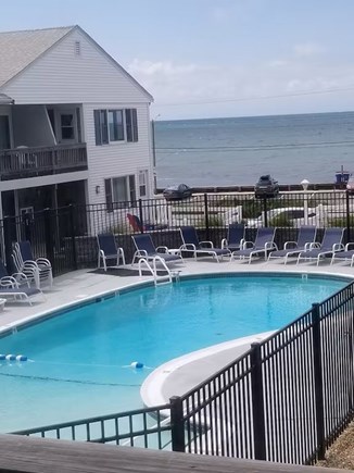 Dennisport Cape Cod vacation rental - Balcony view and heated pool with lounge chairs