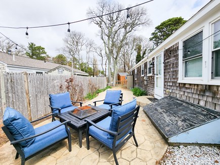 Dennisport Cape Cod vacation rental - Back seating with string lights and privacy.