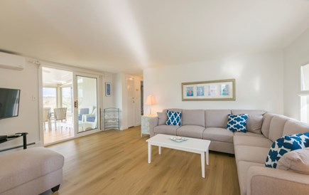 Sagamore Beach Cape Cod vacation rental - Living room with TV and access to the sunroom.
